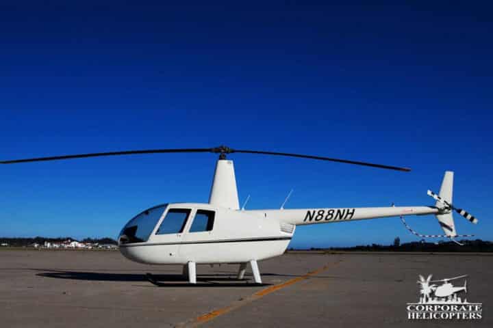 Side view of a white 2013 Robinson R44 Raven I helicopter