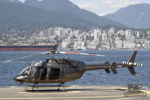 2013 Bell 407GX helicopter landed next to a bay