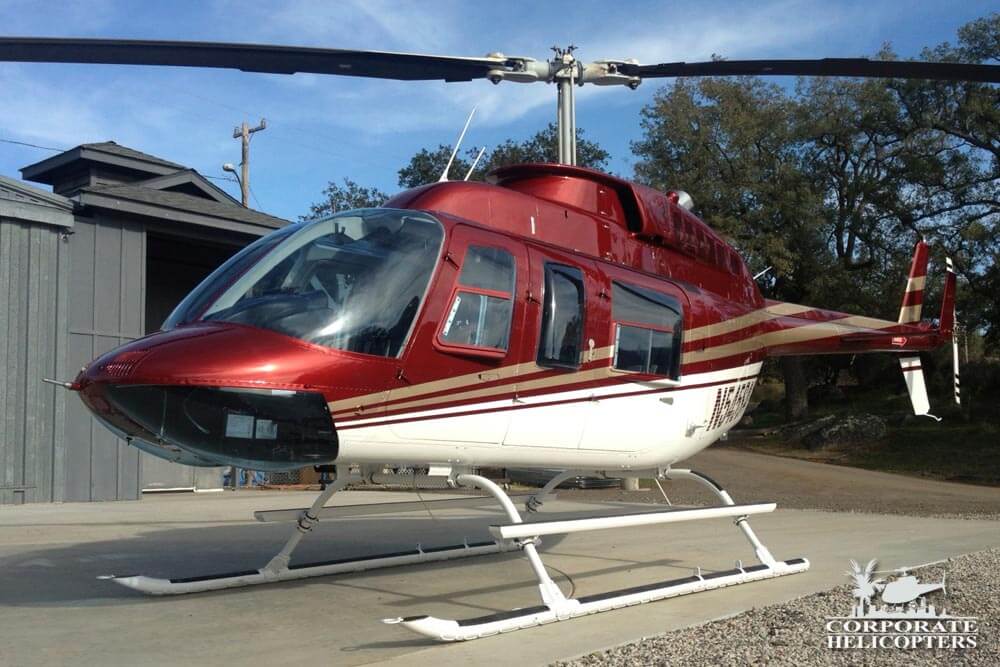 Red and White Bell 206L3 helicopter
