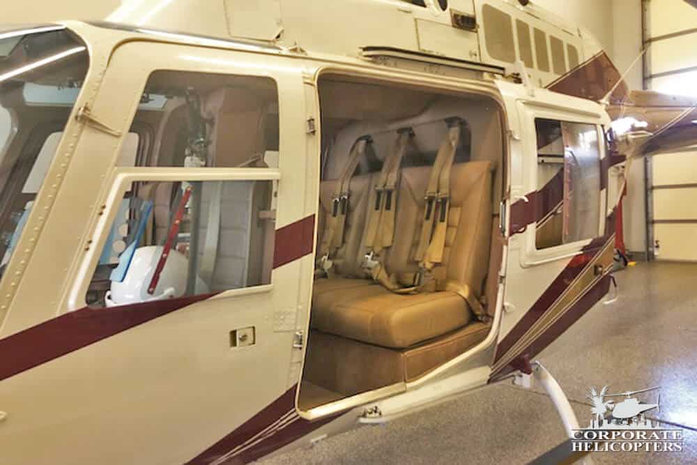 1973 Bell 206B II helicopter in a hangar with the door off.