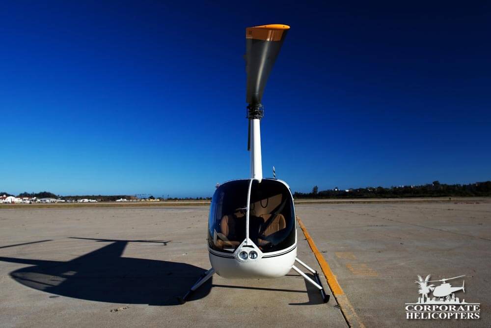 Front view of a 2013 Robinson R44 Raven I helicopter on an airfield
