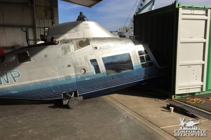 Agusta helicopter being loaded into shipping container