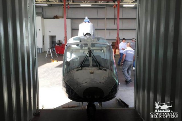 Helicopter being loaded into cargo container