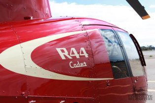 Closeup of R44 Cadet text on the side of a red helicopter