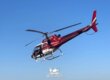 Red and white helicopter in flight