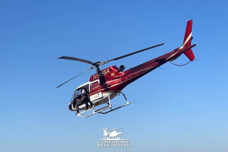 Red and white helicopter in flight