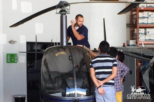 Students watch as teacher talks about a helicopter rotor
