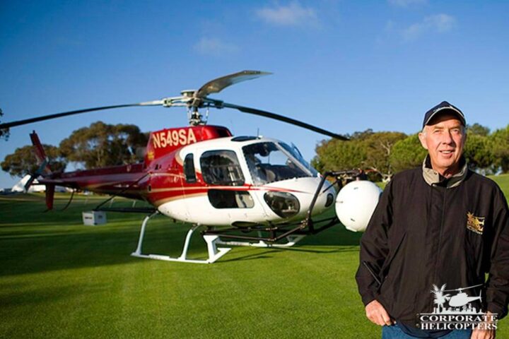 Ivor Shier in front of a helicopter on a golf course