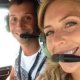 A couple smiling inside of a helicopter