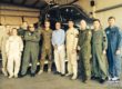A group of National Test Pilots pose in front of a helicopter