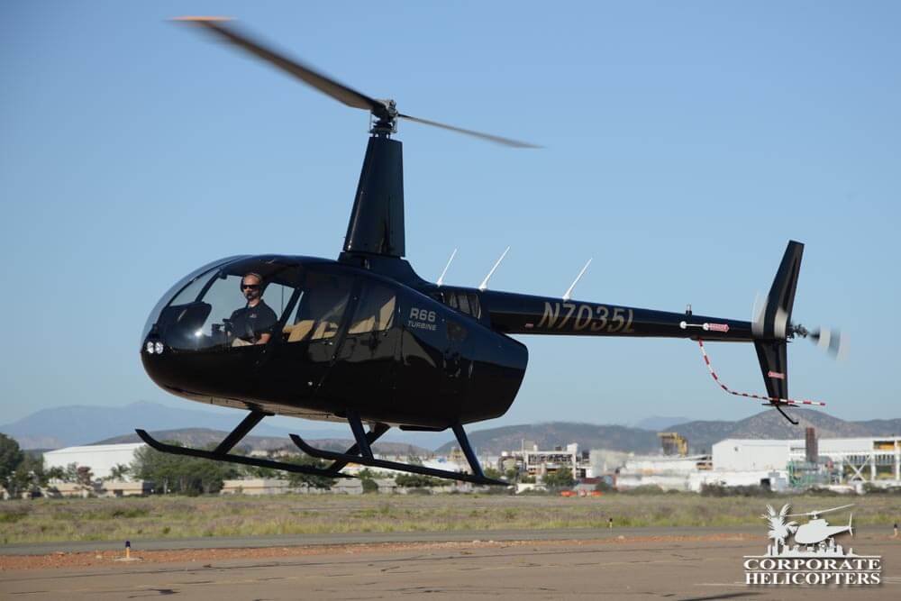 2014 Robinson R66 Turbine hovers above the ground