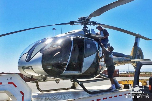 Men prepare a helicopter for shipping