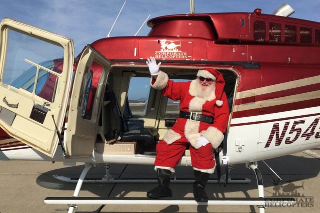 Santa Claus sitting in a helicopter
