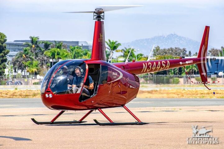 Robinson R44 with the door off, landed on airfield