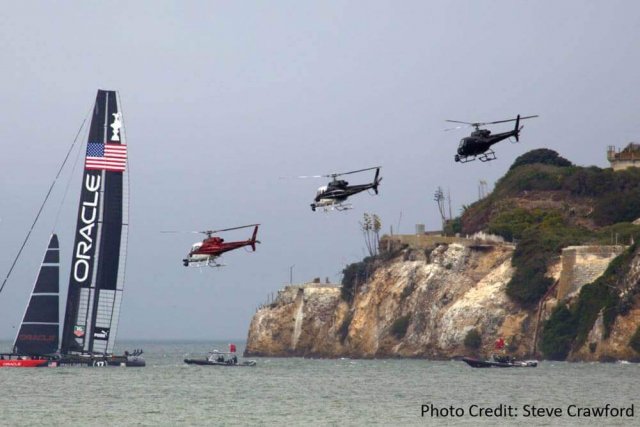 A large boat race and three helicopters