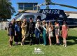 Bachelorette party posing in front of a helicopter at Callaway Winery.