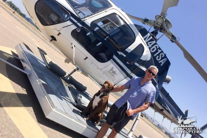 Blade the Dog with owner next to a helicopter
