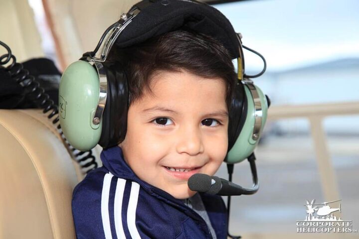 Child inside of a helicopter with headphones on