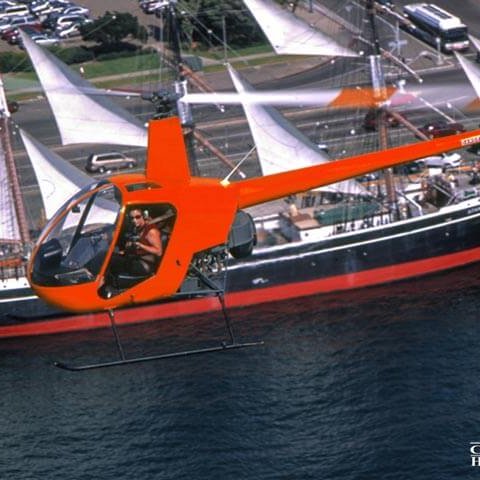 Helicopter flying over the Star of India in San Diego, with a photographer passenger