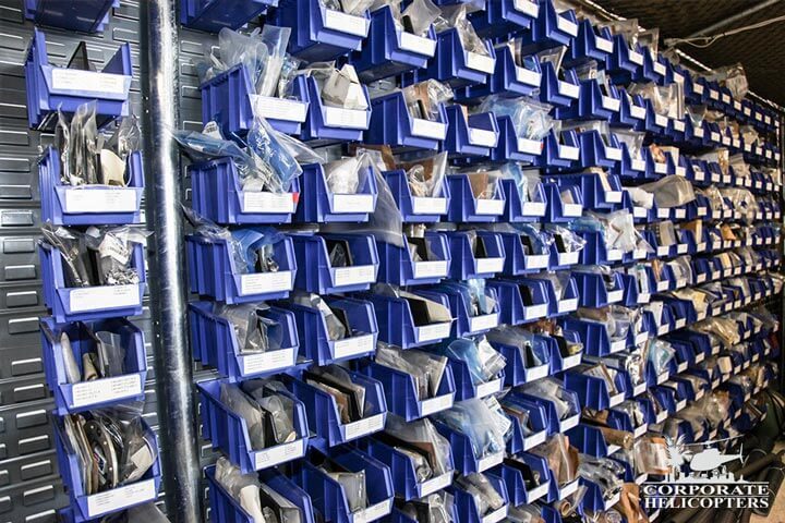 A large organized storage rack of helicopter parts