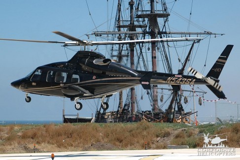 Bell 430 lands next an old ship