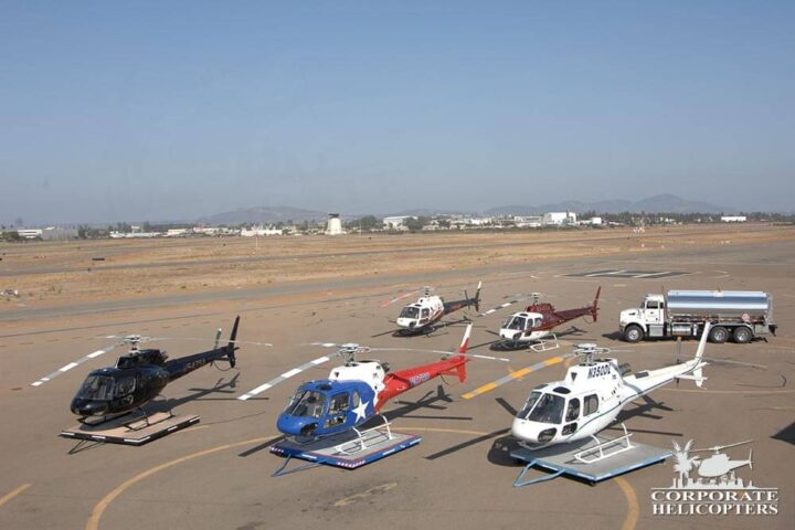5 Astar helicopters and a fueling truck on an airfield