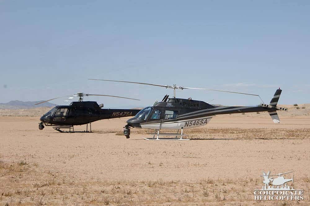 2 aerial filming helicopters landed next to each other in the desert