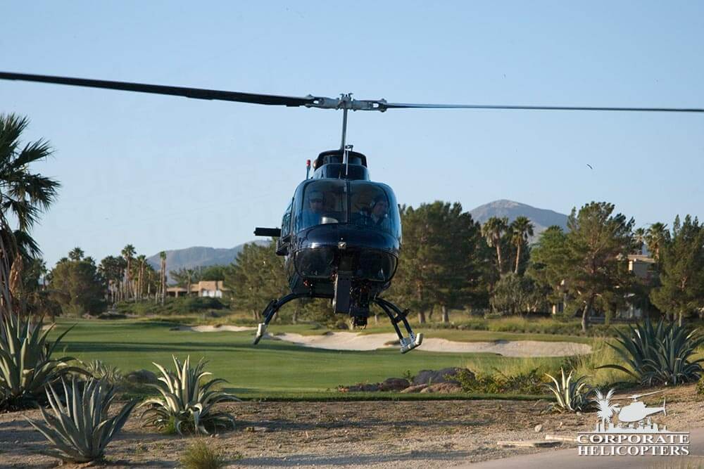 Jetranger helicopter lands next to a golf course in Borrego Springs