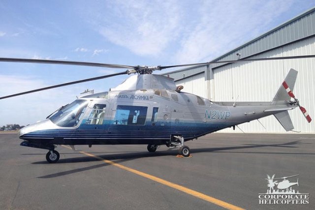 1987 Agusta 109A MKII Plus helicopter landed next to some hangars