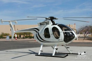 2010 McDonnell Douglas MD 500E helicopter landed on an airfield