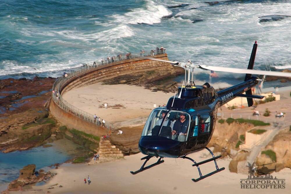 A helicopter flies over the Children's Pool in La Jolla