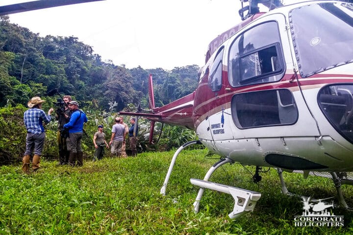 A helicopter and crew landed in the jungle