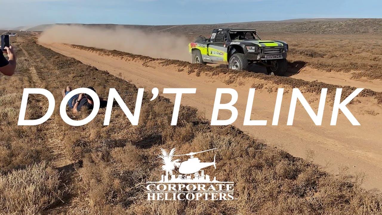 Off road race car racing through desert. Text reads: Don't Blink