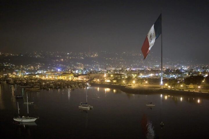 Aerial photo of Ensenada at night, shows the large Mexican flag