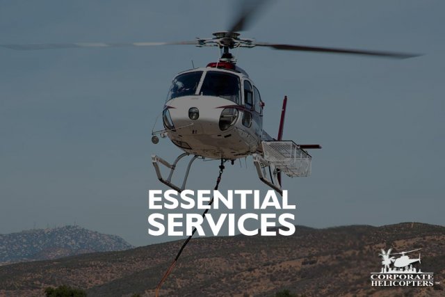 Helicopter with cargo basket and long line attached. Text overlay reads: Essential Services
