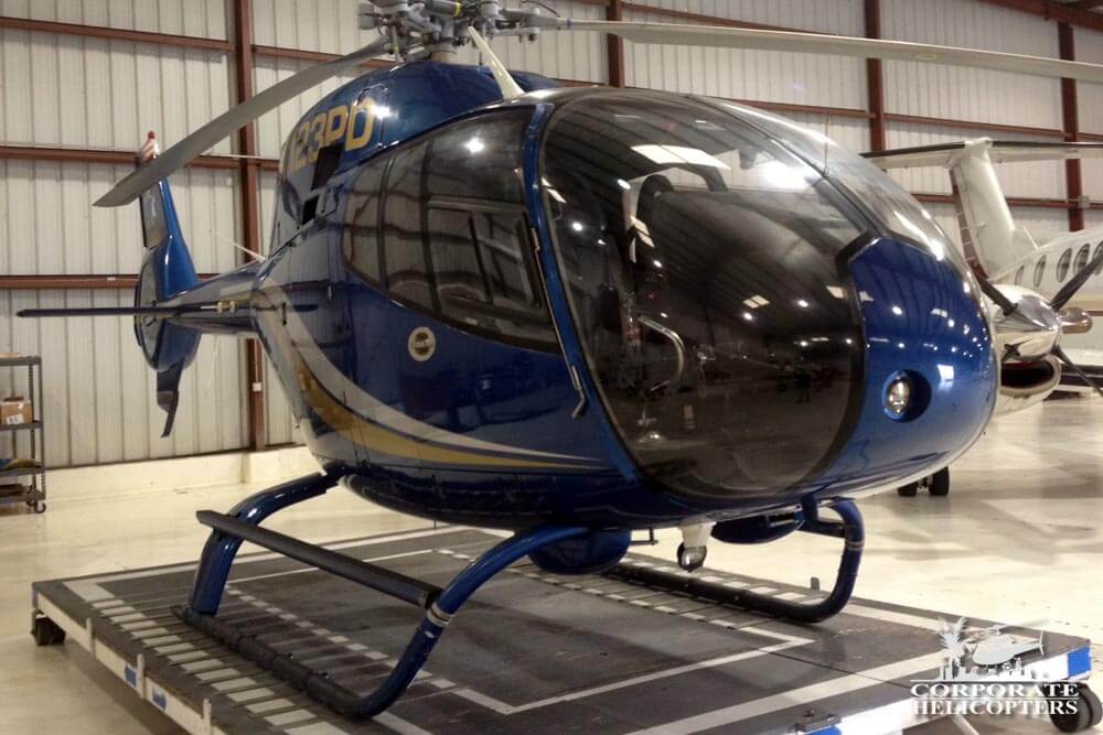 Blue 2001 EC 120 helicopter in hangar