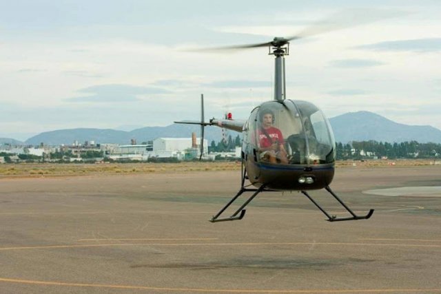 Private helicopter pilot hovers helicopter