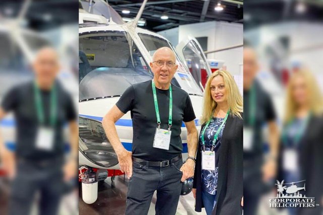 Ivor and Deann Shier stand in front of a helicopter at the 2020 HAI HELI-EXPO.