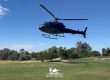 Helicopter taking off from a golf course green