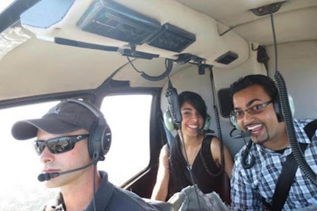 Couple pose as passengers on a helicopter tour