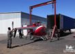 Helicopter being loaded into a shipping container