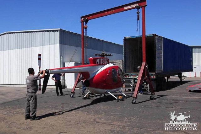 Helicopter being loaded into a shipping container