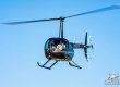 Helicopter in flight, a Shotover B1 Camera is attached to the nose
