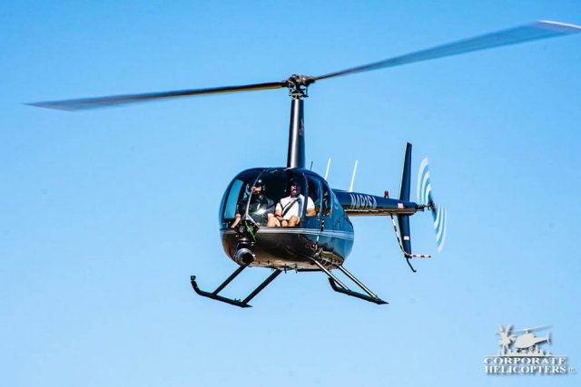 Helicopter in flight, a Shotover B1 Camera is attached to the nose