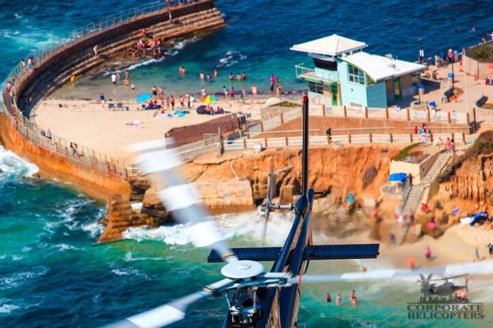 helicopter tail seen in foreground, La Jolla cove in the background