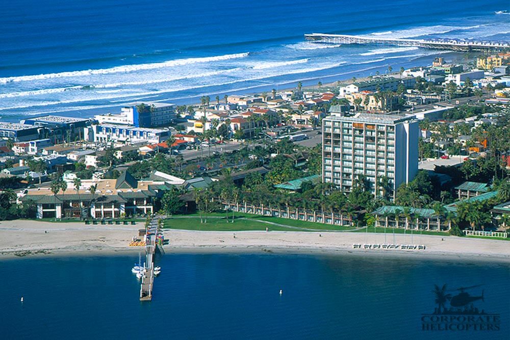 Helicopter tour from Corporate Helicopters of San Diego. Helicopter flying over the Catamaran on Mission Bay.