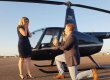 Man proposing to fiancee in front of helicopter