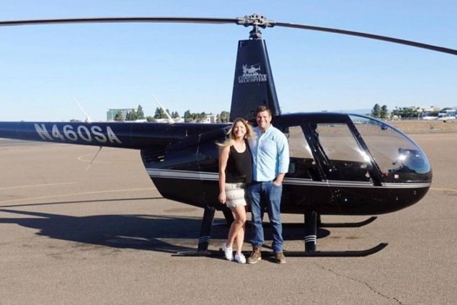 Couple in front of helicopter