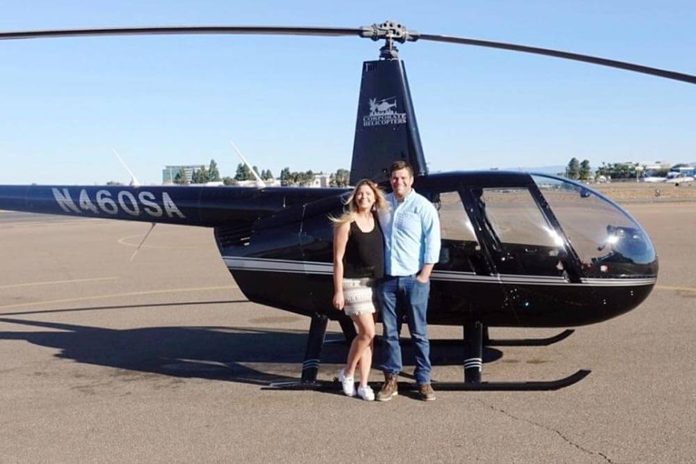 Couple in front of helicopter
