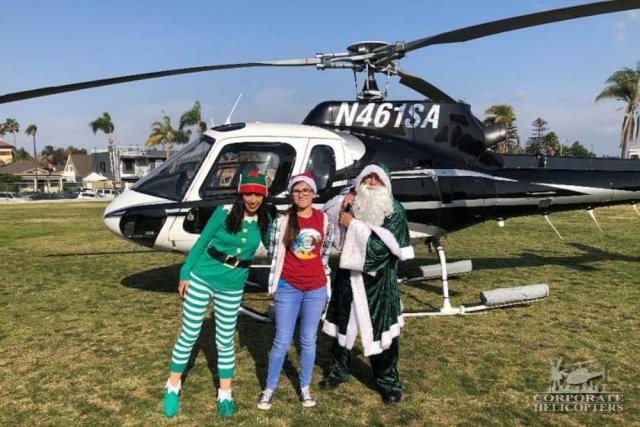 Irish Santa with elves in front of helicopter